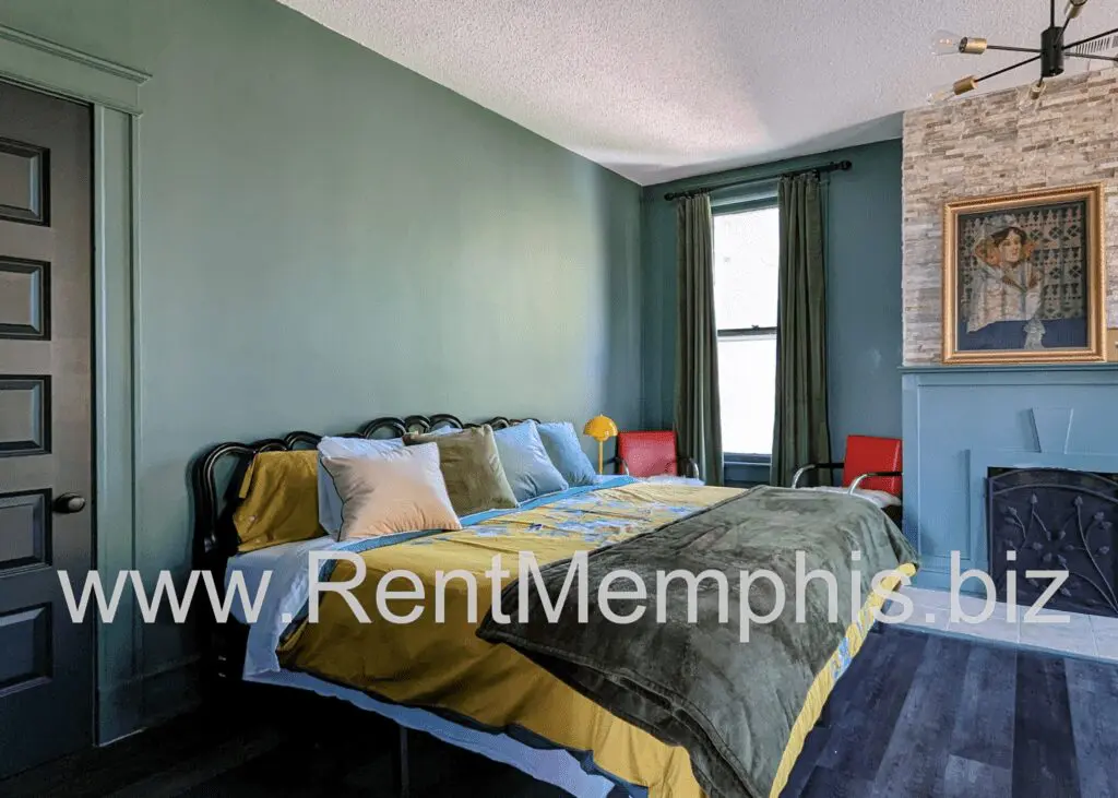 Bedroom with green walls and yellow bedding