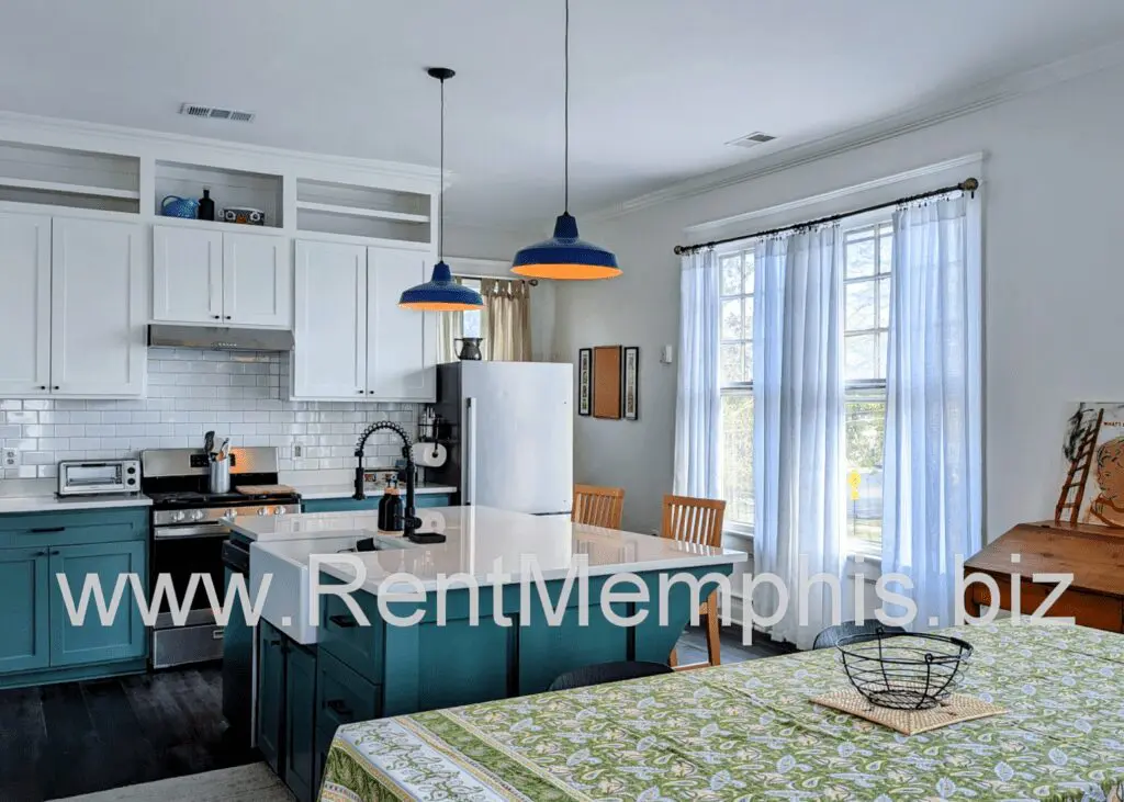 Sunlit modern kitchen with island and dining table